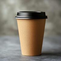 Brown paper coffee cup on a textured surface in a cozy cafe setting photo