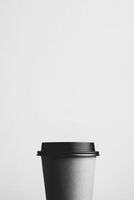Black disposable coffee cup on a plain white background photo