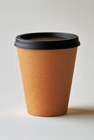 Reusable paper cup with black lid for hot beverages on neutral background photo