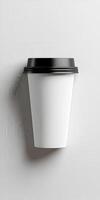 Blank disposable coffee cup on neutral background ready for branding photo