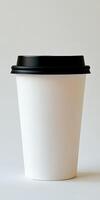 Simple white disposable cup ready for coffee or tea service in modern cafes photo