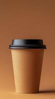 Paper coffee cup with black lid on a smooth brown background photo