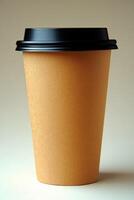 Disposable brown cup with black lid placed on a light background photo
