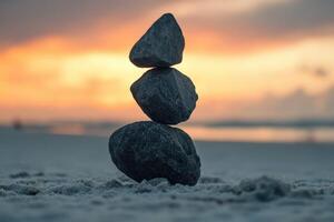 Stacked rocks create a tranquil focal point at sunset on the beach photo