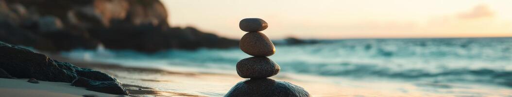 Balancing stones on the beach during sunset near the ocean shore photo