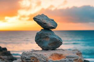 Balancing rocks at sunset near the ocean shore photo