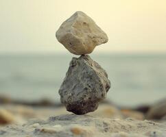 Rock balancing at sunset by the shoreline creates a serene atmosphere photo
