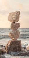 Balancing stones at the beach during sunset creates a peaceful atmosphere photo