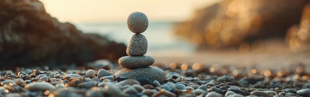 Stacked stones on a beach at sunset creating a peaceful atmosphere photo