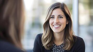 HR manager conducting a one-on-one interview with a smiling candidate in a modern office environment photo