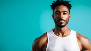 Portrait of a confident and handsome African American man with a well-groomed beard,wearing a white tank top,standing against a teal blue studio background,exuding a sense of style and masculinity. photo