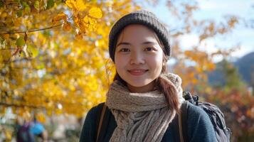 Cheerful Asian Woman Enjoying Autumn Nature in Lush Park Surrounding photo