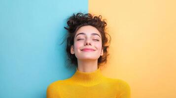 Confident Woman with Curly Hair Smiling Joyfully in Yellow and Blue Studio photo
