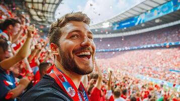 Euphoric Caucasian Male Soccer Fan Cheering and Celebrating His Team's Victory with Raised Arms,Surrounded by a Crowd of Enthusiastic Supporters and Confetti at a Stadium During a Championship Match photo
