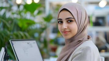 Portrait of a young Muslim female wearing a hijab working diligently on an engineering project with a confident and empowered expression. photo