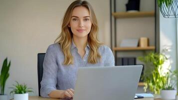 Portrait of a young,stylish Caucasian female manager sitting at her desk in a modern office,using a laptop computer and working diligently in a marketing agency. photo
