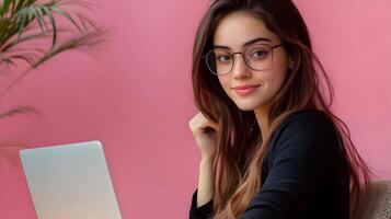 Confident and Intelligent Young Female Professional Using Laptop Computer in Casual Office Setting,Representing Technology,Software Engineering,or Information Technology Expertise photo