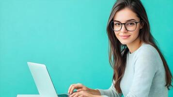 Confident and Capable Young Female IT Specialist or Software Developer Using Laptop Computer for Coding,Programming,and Completing Digital Work Tasks in a Modern Workspace or Office Environment photo