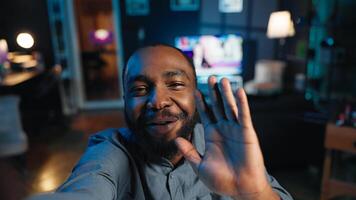 Point of view shot of content creator using smartphone to do live broadcast for subscribers, showing his home studio. Online star films himself for viewership using cellphone camera, POV perspective photo