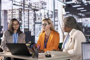 Multiethnic business leaders strategizing for corporate success and gender equality in a men dominated world. Empowered managers with leadership skills are working on their success story. photo