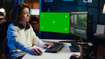 editor analyzing film montage on isolated screen display, editing color grading in office. Post production studio employee working with raw footage on chroma key PC, camera B photo