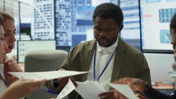 Enterprise manager works with his staff on creating a business strategy and setting goals, studying market dynamics and sales numbers. Corporation team attends a development meeting. Camera A. photo
