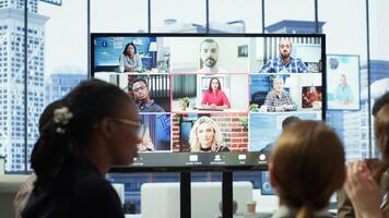 Diverse team of workers reviewing project updates together with shareholders on call online meeting, ensuring easy remote collaboration for global business expansion plans. Teamwork. Camera A. photo
