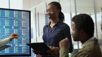 Team of company analysts reviews feedback on sales to work on future improvements, developing marketing and PR strategies in meeting room. Startup enterprise affiliates. Camera A. photo