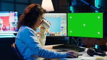 Content specialist uses graphic design skills to make social media post on green screen computer for advertising company. Photo editor using chroma key PC monitor to create promotional image, camera A