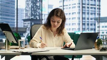 Female leader with executive power signing work contracts and approving employees requests, daily paperwork tasks for productivity. Authorization for leave request or license agreement. Camera A. photo