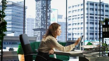 Businesswoman with leadership skills creates a financial report, demonstrating her expertise in analysis, forecasting and ensuring the organizational stability within market conditions. Camera B. photo