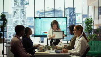 Business associates reviewing key performance indicators within the enterprise activity. Conducting evaluations and discuss training to foster development, enhance team efficiency. Camera B. photo