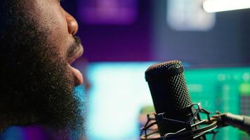Skilled composer producing a new melody with lyrics and piano keys, recording audio files to edit them with mixing console. Young talented artist producer creating soundtracks. Camera A. photo