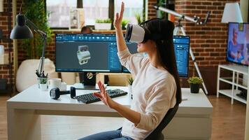 Asian woman engineer creating prototypes with vr glasses and 3D modeling software, working from home to develop new manufacturing gears and turbines. 3D design tech tools. Camera A. photo