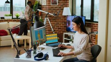 Creative woman manages photo editing and design projects on her computer in a tech driven workspace, using digital tools to enhance productivity in the graphic design industry. Camera A.
