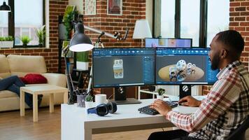 African american industrial designer works on prototypes in a creative studio. Doing tech driven remote work with 3D modeling and CAD software, industrial tools for technical precision. Camera A. photo