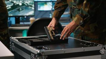 Operatives conducing special operation, loading weapons, preparing to attack enemy forces. Close up of army soldier in command center packing guns for assault mission, camera A photo