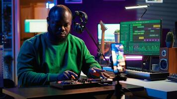 Music producer explaining faders and knobs on mixing console before teaching advanced post production stuff. Musical instructor gives advice about acoustical engineering, online vlog. Camera A. photo