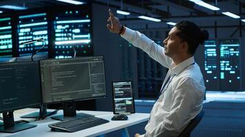 Admin in data center using augmented reality technology to ensure system can handle networking tasks. Server room worker looking at AR visualization hologram, tracking network traffic, camera A photo