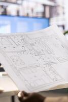 Architect drawing schematics providing technical and aesthetic advice on the design of infrastructures. Close up of architecture specialist designing plans for buildings restorations and alterations photo