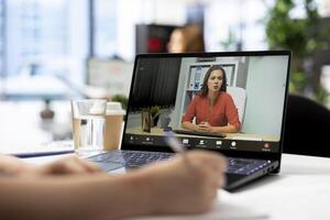 Job interview candidate interested in career advancement, talking with HR employee during videoconference meeting on laptop. Woman talking with recruiter during remote videocall on notebook photo