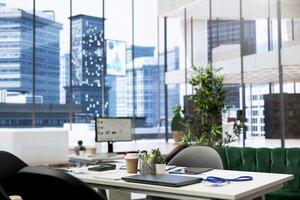 Empty financial department office used for budgeting, forecasting, and financial analysis purposes. Bright modern company workspace with nobody in and devices left open on desks photo