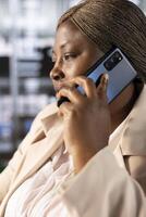 CEO in office talking on phone with partners, ensuring compliance with company policies. Manager in telephone call with shareholders, identifying opportunities for operational cost savings photo