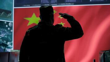 Military analyst from China reviews surveillance data in an army monitoring room headquarters. Chinese soldiers spreading misinformation through propaganda, presenting the national flag. Camera A. photo