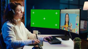 Photo editor using green screen monitor to color correct photographs in creative studio, listening music. Photographer selecting best pictures for editorial content with chroma key computer, camera B