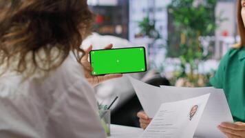 HR team selecting candidates and using a copy space mockup display in high end office, working on finding the best applicant for the job opening. Recruiters review resumes. Camera A. photo
