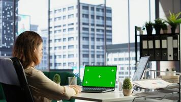 Woman chief executive officer working with mockup copy space screen on device, developing a project for enterprise growth and objectives achievement. Female director with determination. Camera B. photo