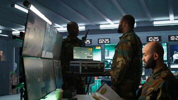 Military officer using tracking software on laptop to gain info helpful against enemies. Army professional using notebook to gain intel helping troops, coordinating mission activities, camera B photo