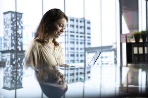 Female entrepreneur working on financial planning and budget allocation, ensuring the company resources are used effectively to achieve maximum profit and long term business objectives. photo