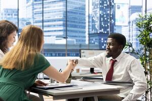 HR expert reviewing candidate with impairment, asking questions about qualifications. Person with disability getting hired for inclusive company after proving enthusiasm for job opportunity photo